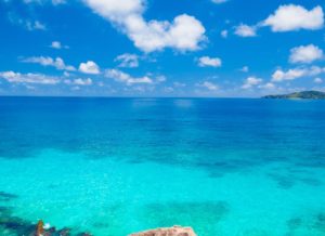 clear turquoise ocean in Bahamas with cloudy sunny skies